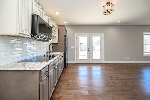 kitchen with sink, stainless steel appliances, dark hardwood / wood-style floors, tasteful backsplash, and french doors