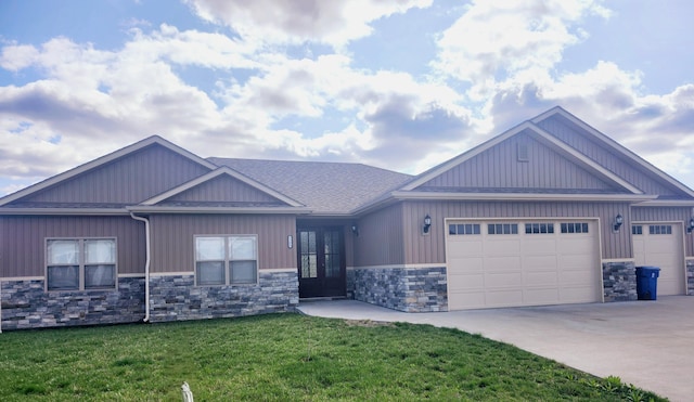 5580 Charlotte Dr, Ashland, MO 65010 - view of front of home featuring driveway, stone siding, french doors, a front lawn, and a garage