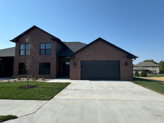 view of front facade with a garage and a front yard