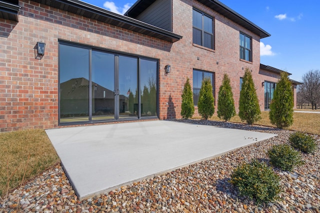 rear view of property featuring brick siding