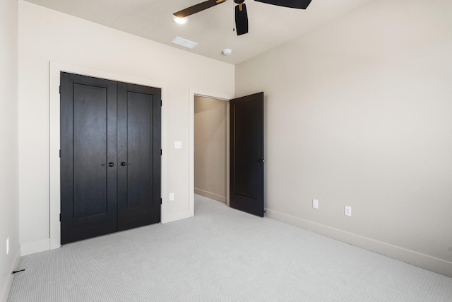 unfurnished bedroom featuring visible vents, baseboards, carpet, and a closet