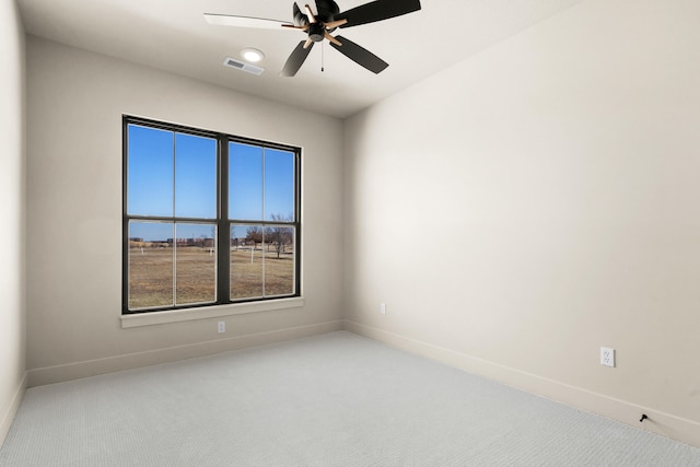 unfurnished room with baseboards, carpet, visible vents, and ceiling fan