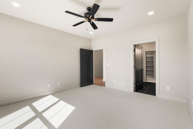 unfurnished bedroom featuring recessed lighting, carpet, visible vents, and baseboards