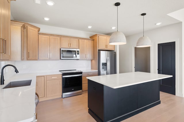 kitchen featuring a sink, appliances with stainless steel finishes, light wood-style flooring, and light brown cabinetry