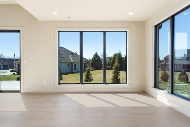 empty room with recessed lighting, visible vents, and wood finished floors