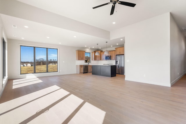 unfurnished living room with baseboards, visible vents, recessed lighting, ceiling fan, and light wood-type flooring