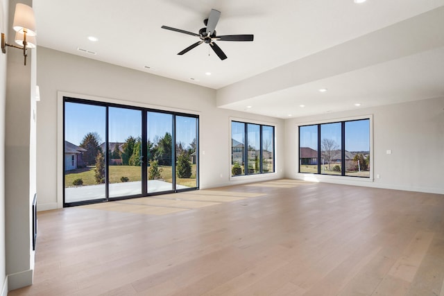 unfurnished living room with visible vents, light wood-style flooring, a ceiling fan, recessed lighting, and baseboards