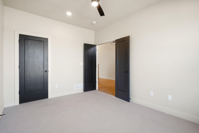 unfurnished bedroom with visible vents, baseboards, carpet, and ceiling fan