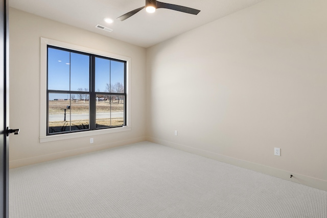 empty room featuring visible vents, baseboards, a ceiling fan, and carpet flooring