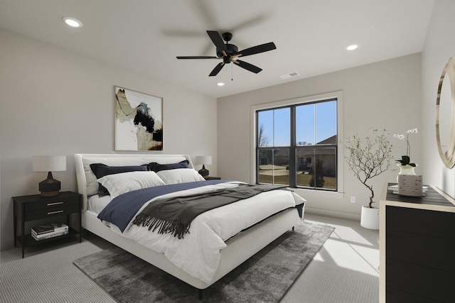 bedroom featuring light carpet, visible vents, and recessed lighting