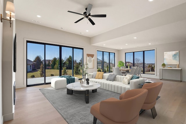 living room featuring ceiling fan, recessed lighting, visible vents, and light wood-type flooring