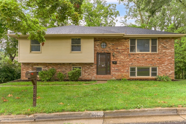 raised ranch with a front yard