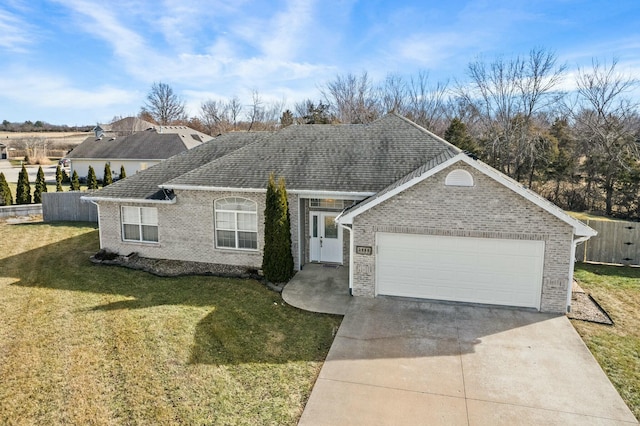 single story home featuring a garage and a front yard