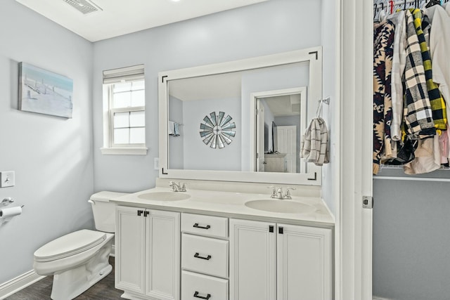 bathroom featuring hardwood / wood-style flooring, vanity, and toilet