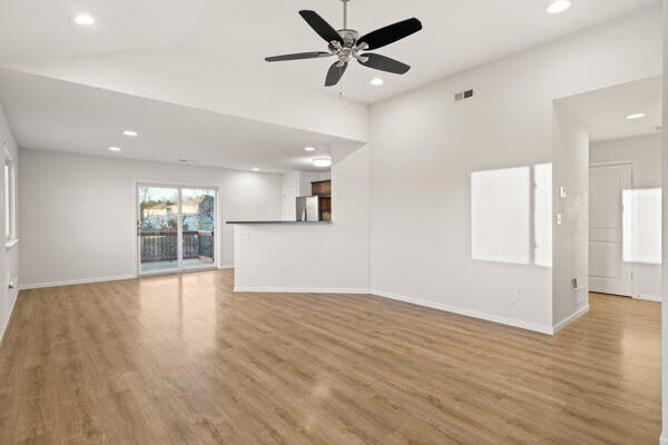 unfurnished living room with ceiling fan and light hardwood / wood-style flooring