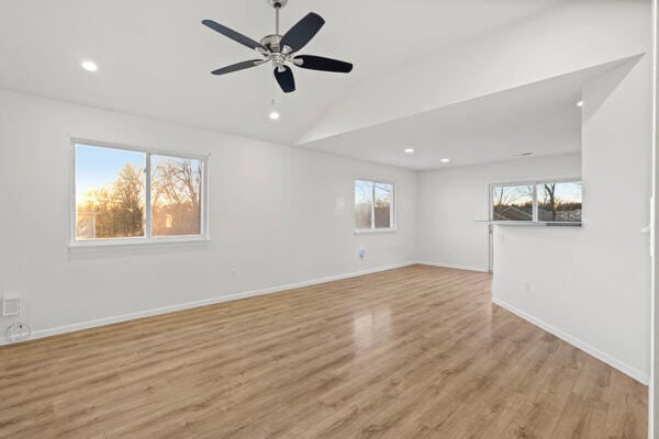 unfurnished room with lofted ceiling, light hardwood / wood-style floors, and ceiling fan