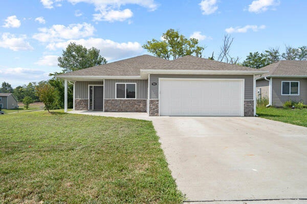 view of front facade with a garage and a front yard