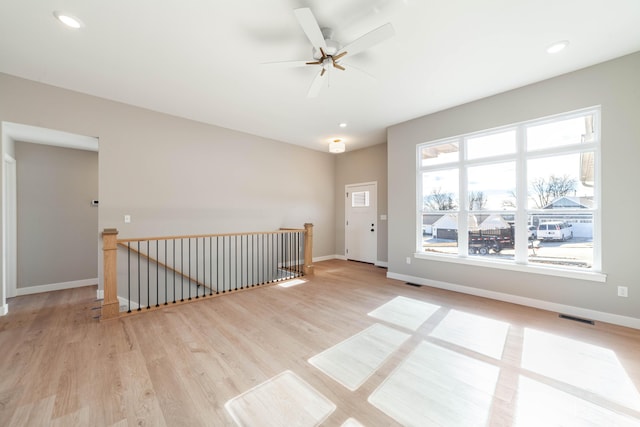 unfurnished room with ceiling fan and light wood-type flooring