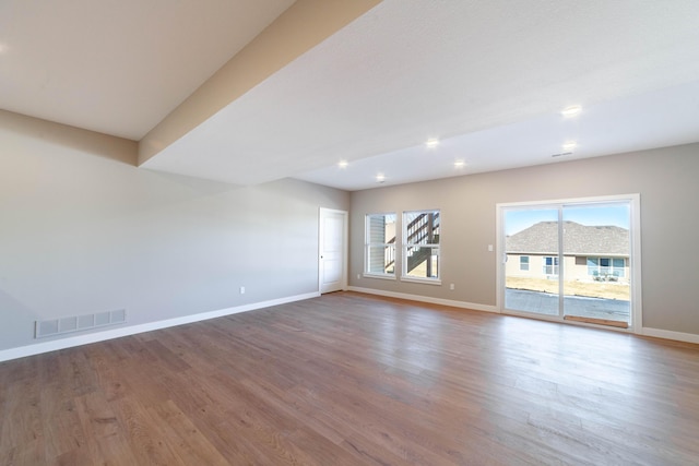 unfurnished room with wood-type flooring