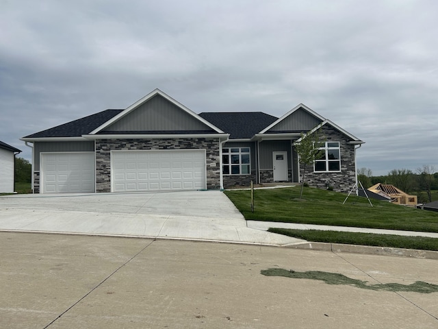 6051 Tamarack Dr, Columbia, MO 65203 - craftsman house featuring stone siding, a garage, a front yard, and driveway
