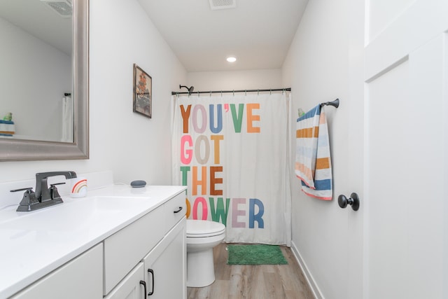 bathroom with vanity, hardwood / wood-style flooring, curtained shower, and toilet