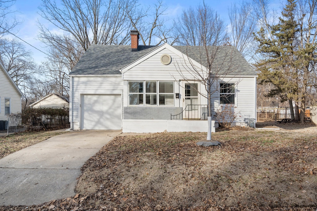 view of front of property with central AC and a garage