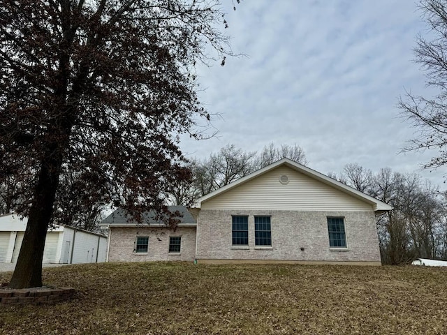 back of property with a lawn