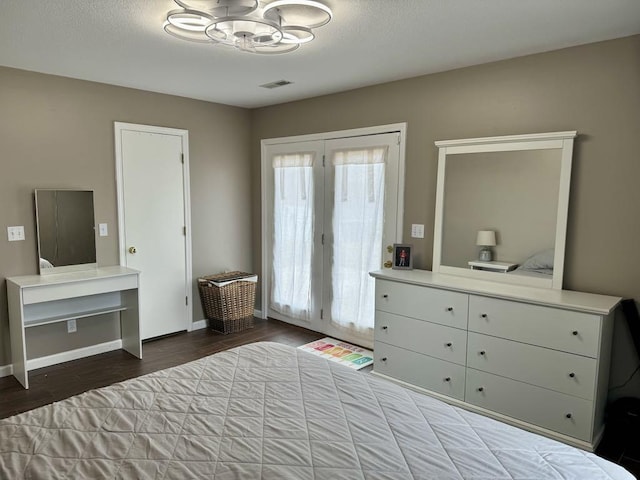 bedroom with wood-type flooring and access to exterior