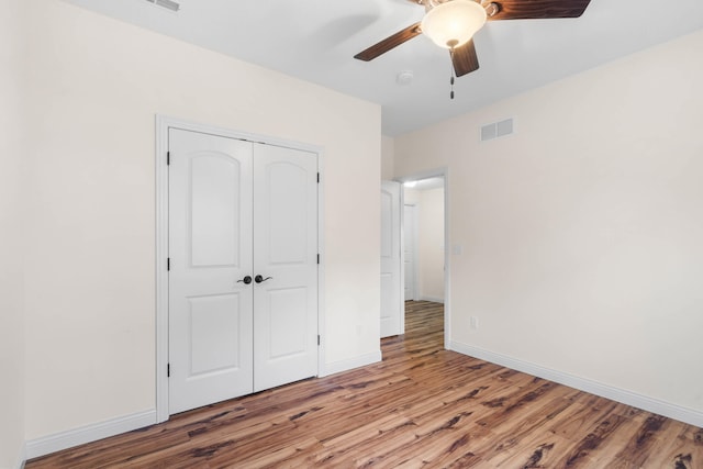 unfurnished bedroom with a closet, ceiling fan, and light hardwood / wood-style flooring