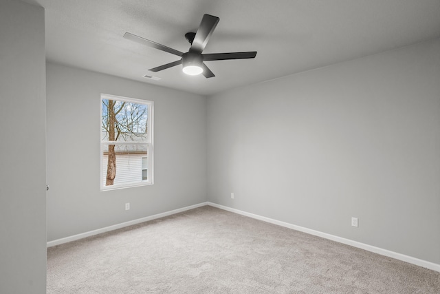 spare room with carpet floors and ceiling fan