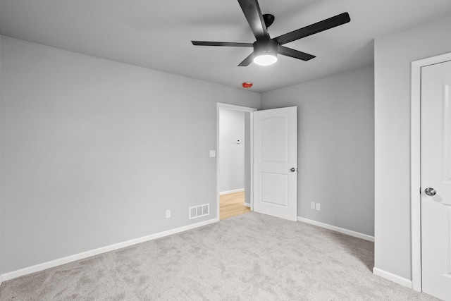 unfurnished bedroom featuring ceiling fan and light carpet