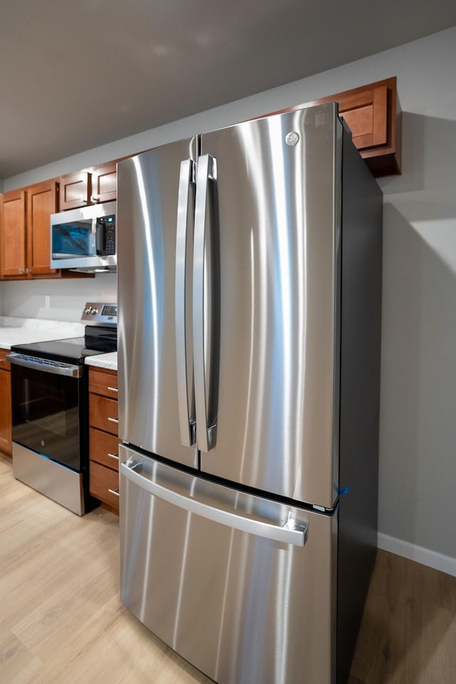 kitchen with stainless steel appliances and light wood-type flooring