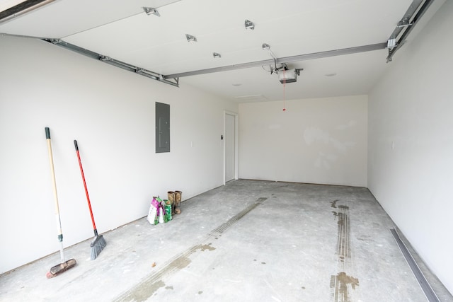 garage with a garage door opener and electric panel