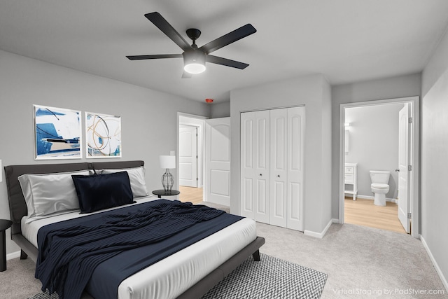 carpeted bedroom with ceiling fan, ensuite bathroom, and a closet