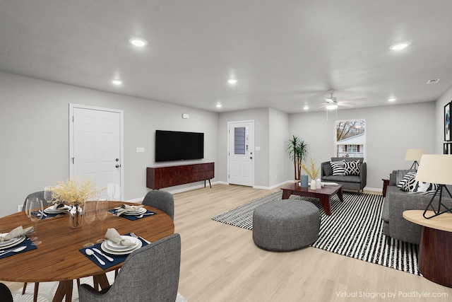 living room featuring ceiling fan and light hardwood / wood-style floors