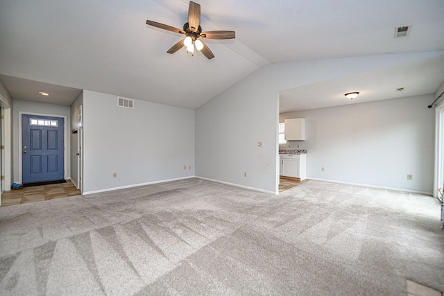 unfurnished living room with ceiling fan, lofted ceiling, and light carpet