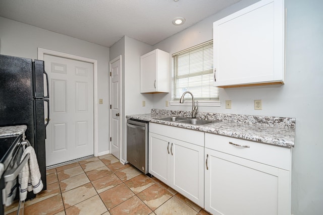 kitchen with sink, white cabinets, light stone counters, stainless steel appliances, and a textured ceiling