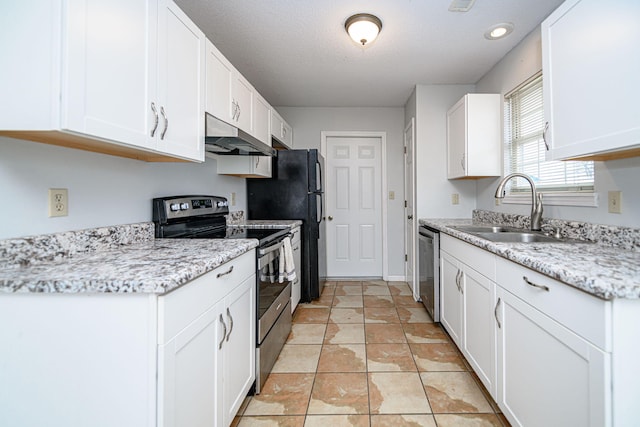 kitchen with light stone counters, stainless steel appliances, sink, and white cabinets