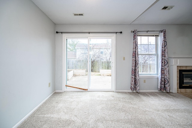 unfurnished living room featuring carpet and a fireplace