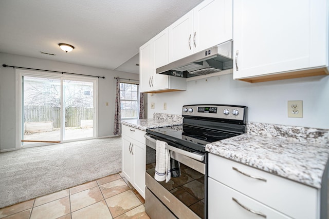 kitchen with stainless steel range with electric stovetop, white cabinetry, light stone counters, a textured ceiling, and light carpet