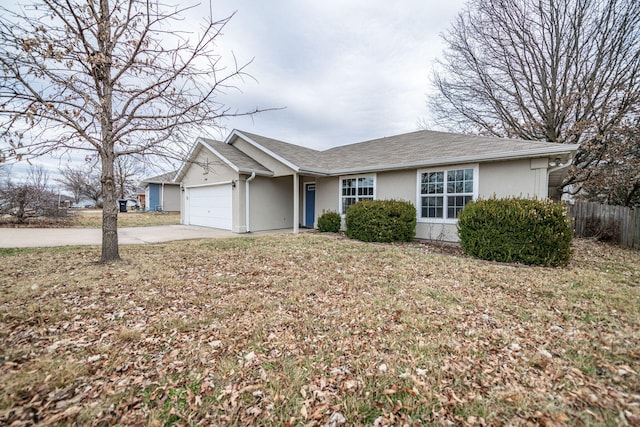 ranch-style house with a garage and a front yard