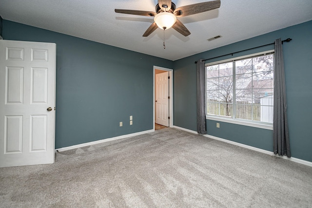 unfurnished bedroom featuring ceiling fan, carpet floors, and a textured ceiling