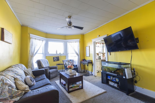 carpeted living room featuring ceiling fan and ornamental molding