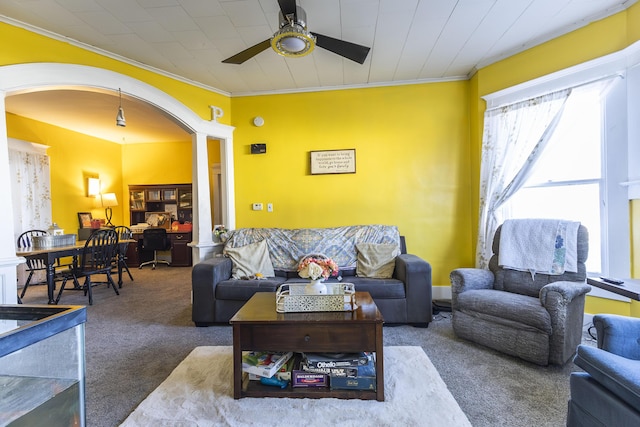 living room with ceiling fan, ornamental molding, and carpet floors