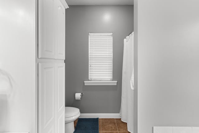 bathroom with toilet and tile patterned flooring