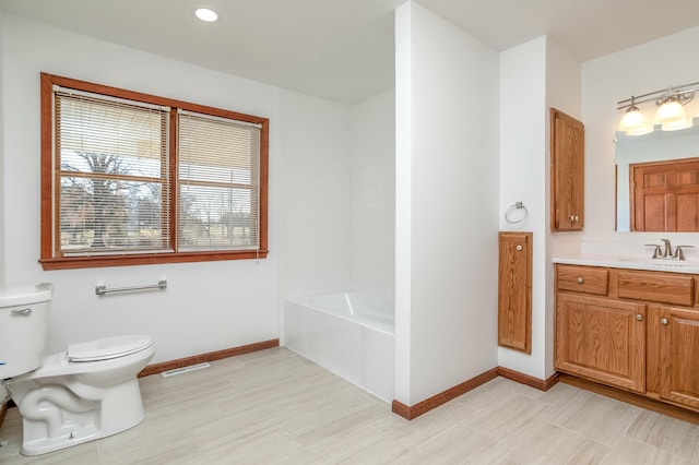 full bathroom featuring visible vents, baseboards, a washtub, toilet, and vanity