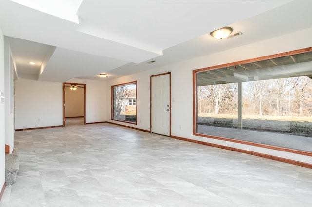 unfurnished room with visible vents and baseboards