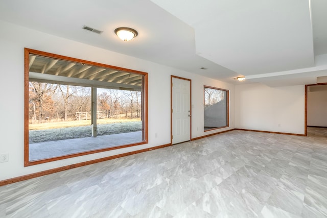 spare room featuring baseboards and visible vents