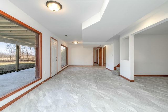 empty room with baseboards and stairs