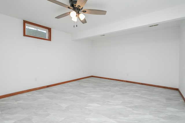 unfurnished room with visible vents, baseboards, and a ceiling fan